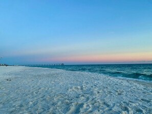 A beach with a pier extending into the water. - Azure Resort Luxury, Exceptional Value (Fort Walton Beach)