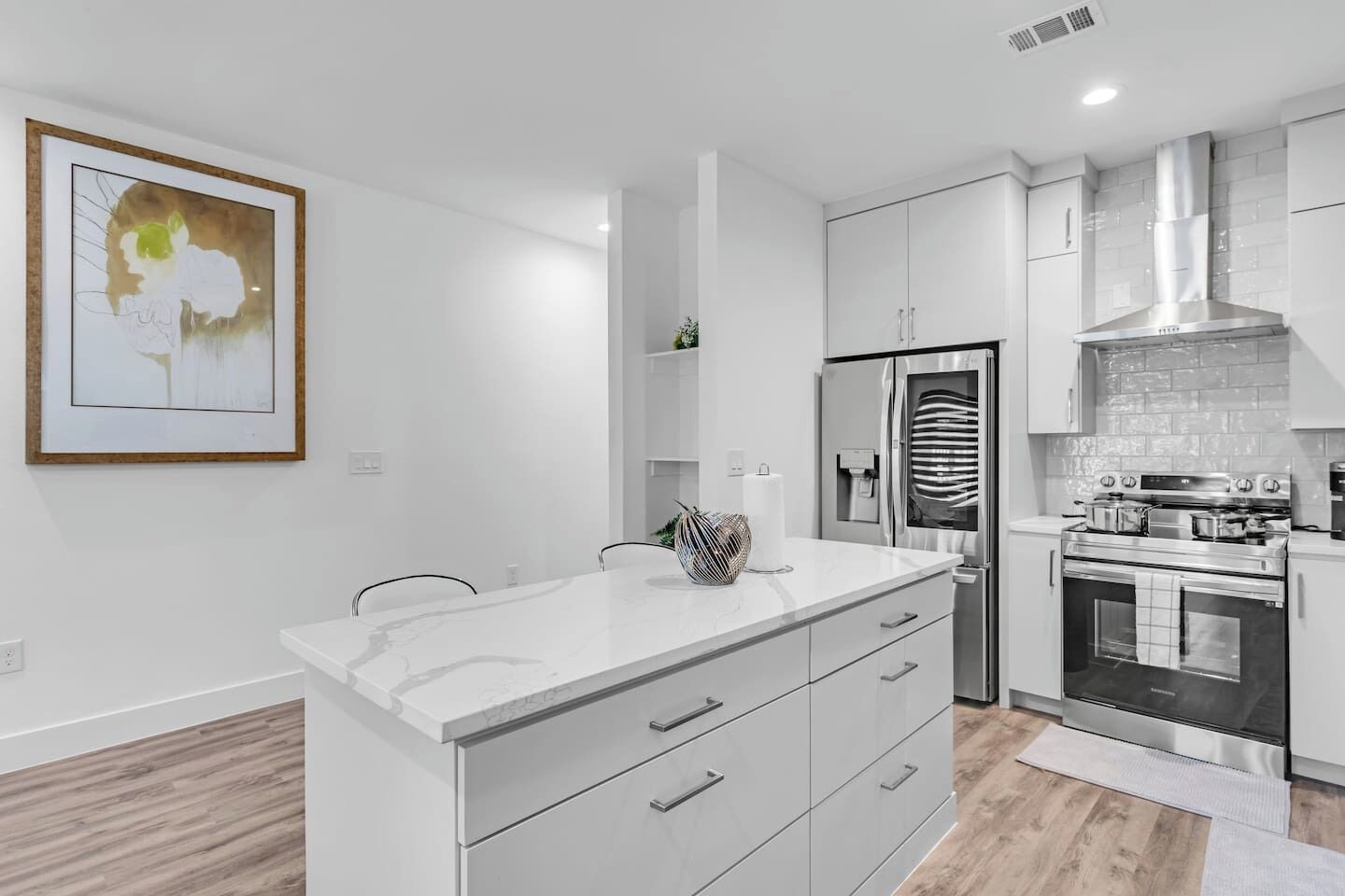 Brand new, open-concept kitchen with stainless steel appliances and island.