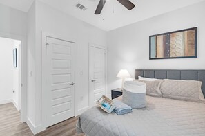 Another modern guest bedroom with a bright window and neutral palette