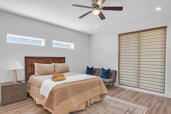 Spacious primary bedroom designed for comfort and relaxation with room darkening shades.