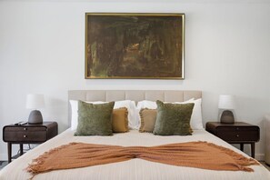 Primary king suite styled with fresh towels neatly arranged on the bed, adding a welcoming, hotel-style touch to your stay.