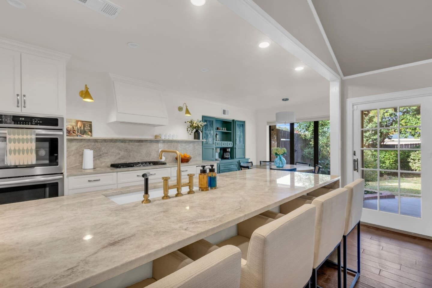 Huge kitchen anchored by an oversized island, offering ample counter space for cooking, meal prep, and casual dining. Designed for both function and style, the open layout makes it easy to gather, entertain, and move seamlessly between the kitchen, l