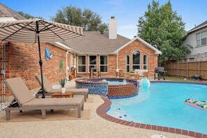 Dive into our refreshing pool, unwind in the inviting hot tub, and savor the sizzle of a BBQ grill amidst the comfort of lounge beds, the perfect recipe for a day of relaxation and outdoor enjoyment. - Frisco Pool Retreat | BBQ, Hot Tub & Shuffleboard (Frisco)