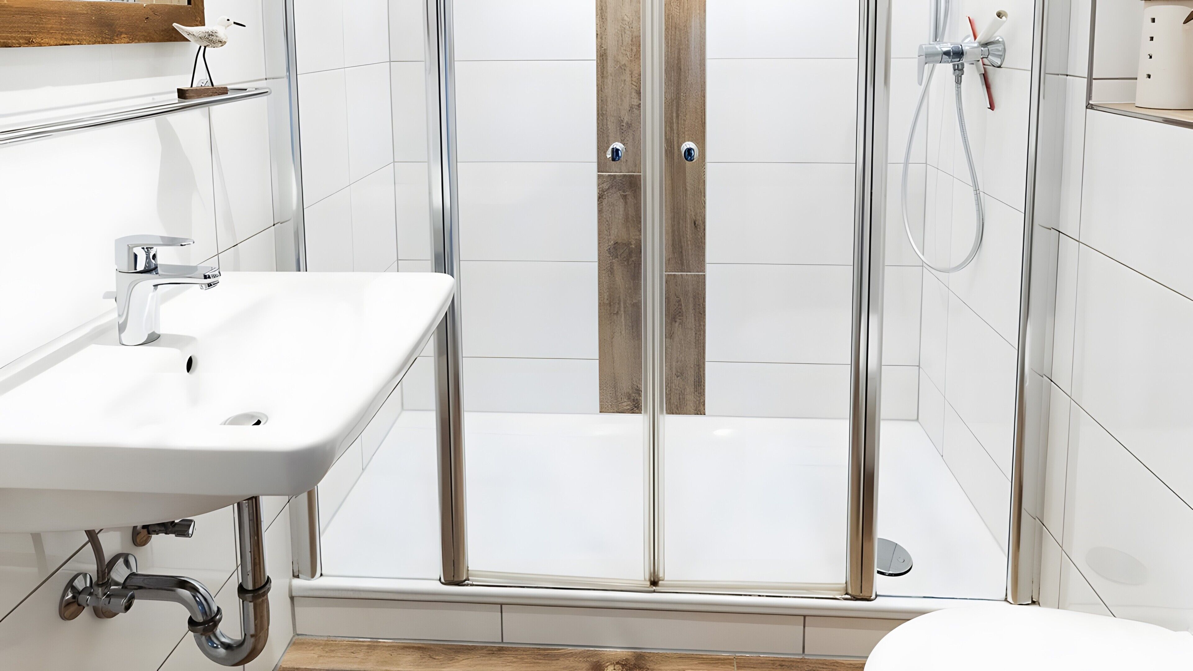 A modern bathroom with a glass-enclosed shower, a white sink, and a wooden shelf.