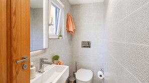A bathroom with a sink, mirror, toilet, and towel rack. - Wonderful 4BR Farmhouse with Private Pool (Rabat)