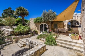 A courtyard with stone steps, a table and chairs, and a large tree. - Wonderful 4BR Farmhouse with Private Pool (Rabat)