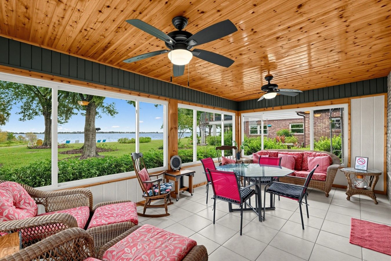 A covered patio with a table and chairs, wicker furniture, and a view of the outdoors.