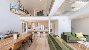 A modern interior with a dining area, kitchen, and living space.