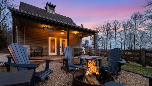 A wooden cabin with a covered patio, outdoor seating, and a fire pit. - Blue's Barn (Nellysford)