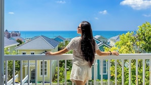 A balcony with a view of the ocean and houses. - Novaworld Phan Thiet - Mira Villas (Tien Thanh)