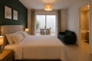 A hotel room with a large bed, a desk, a chair, a sofa, and a view of the outdoors. - Luxury residence near Monaco with parking and swimming pool (Beausoleil)