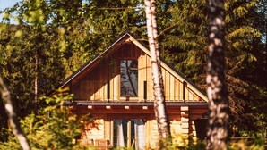 A wooden cabin surrounded by trees.