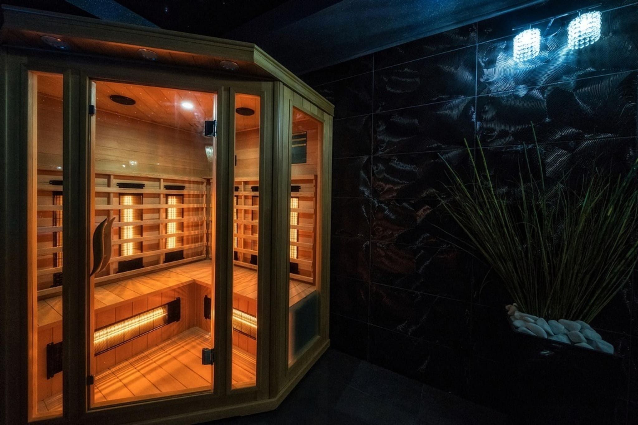 A sauna with wooden benches and a tiled wall.