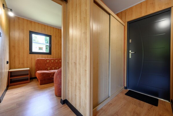 Habitació amb porta corredissa, finestra, sofà i taula petita.