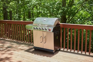 A portable barbecue grill on a wooden deck with a metal railing. - Black Bear Resort - Serene Cabin Retreat | Views, Deck & Resort Access (Davis)