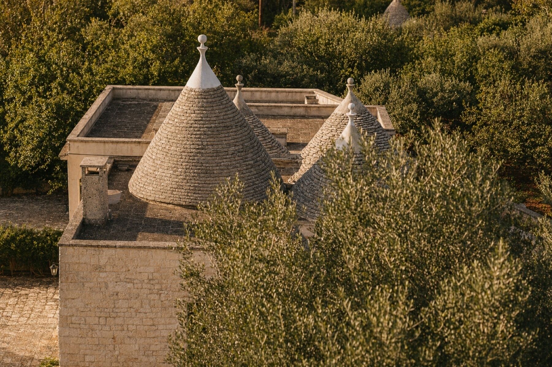 A building with a stone facade and multiple conical roofs.