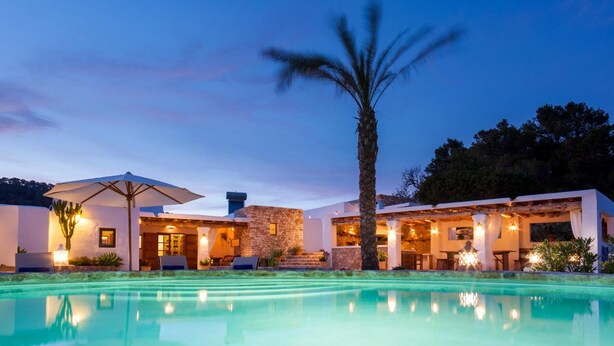 A modern resort with a pool, outdoor seating, and a well-lit patio area. - Villa 'Sa Paissa De Can Sergent' with Mountain Views, Wi-Fi, and Air Conditioning (Cala Vedella)