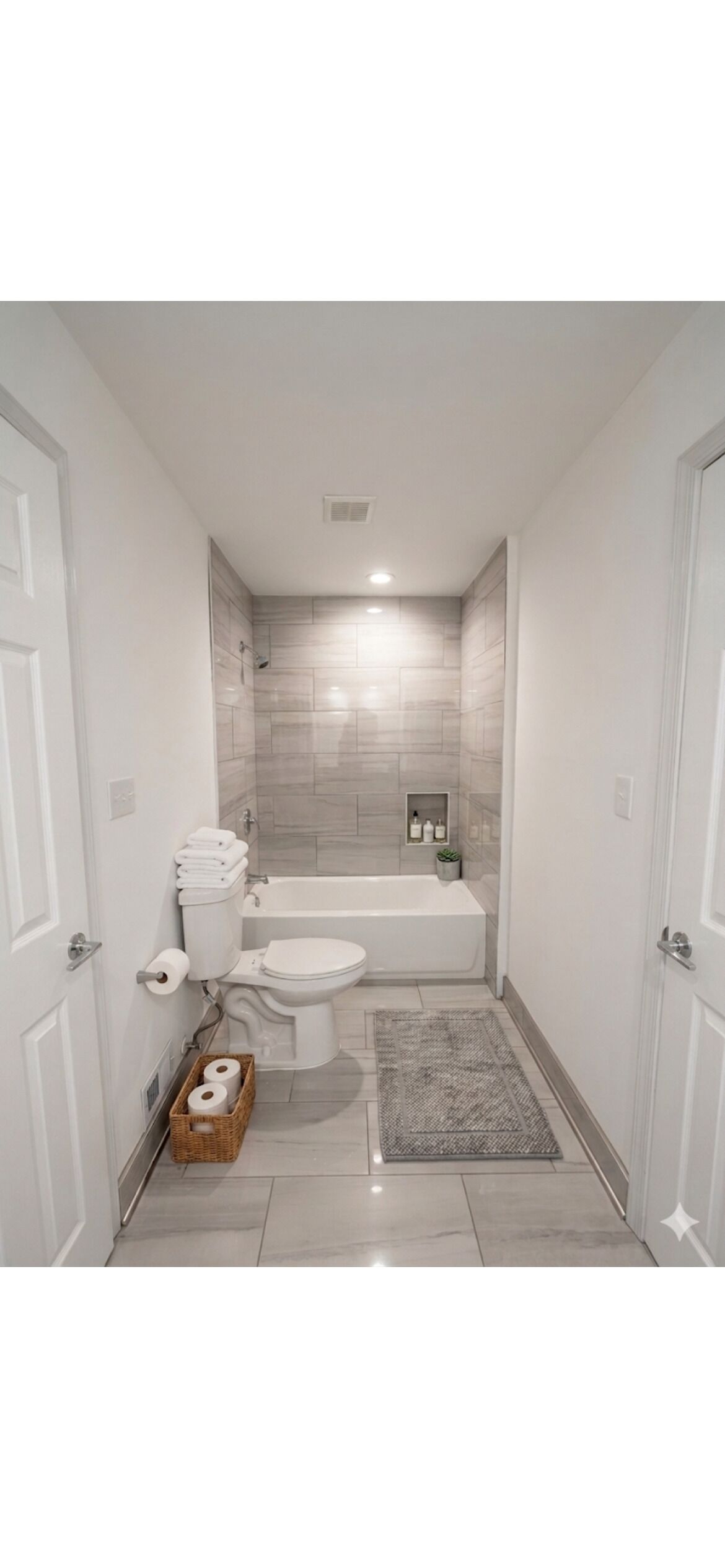 A bathroom with a toilet, bathtub, and a shower area.