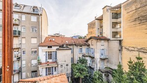 A narrow street between buildings with balconies, a tiled roof, and some greenery. - EasyComo - Holiday Home MM (Como)
