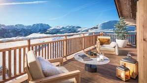 A wooden deck with a view of snow-covered mountains, a chair with a cushion, a small potted plant, and two lanterns. - TERRESENS - La Perle d'Alba (Huez)