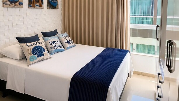 A hotel room with a bed, a second bed, a wardrobe, a window with curtains, and artwork on the wall. - Fully Furnished Duplex Apartment in Porto Seguro - Swimming Pool - 200m from the Beach (Porto Seguro)