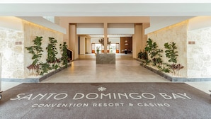 A convention resort and casino with a central reception area, potted plants, and a marble floor. - Santo Domingo Bay (Boca Chica)
