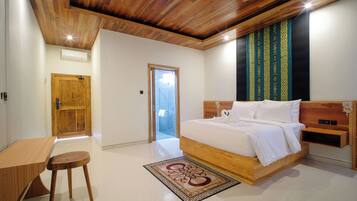 A bedroom with a wooden ceiling, a bed with white bedding, a wooden nightstand, and a small stool.