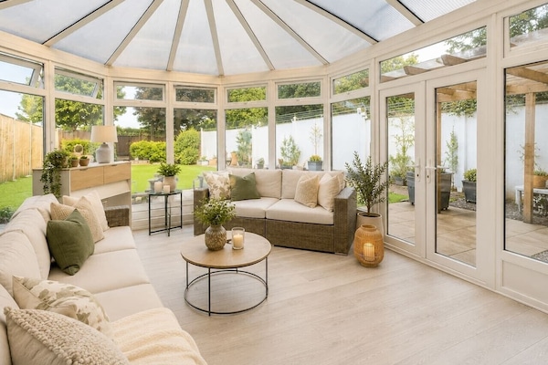 A sun-drenched sanctuary with an airy, conservatory feel—perfect for morning coffee and greenery views.