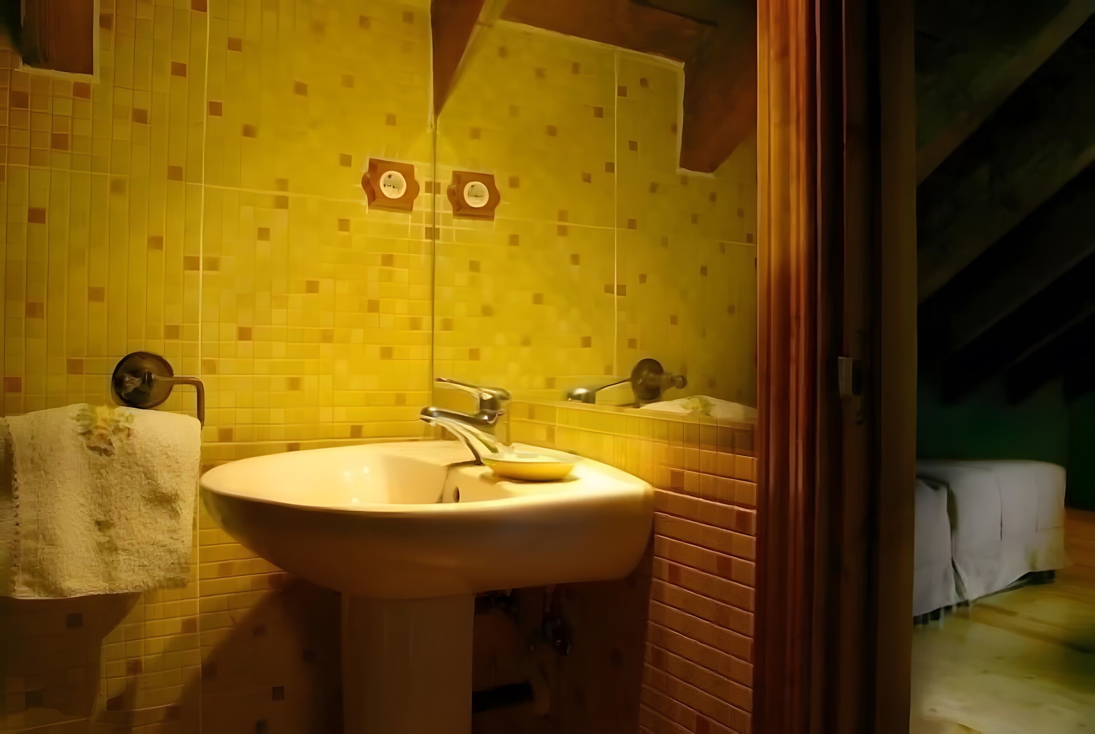 A bathroom with a sink, mirror, and towel rack.