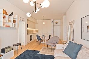 A modern apartment with a kitchen, dining area, and living room. - Ribeira 6 - Boavista Design and Comfort (Lisbon)
