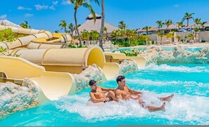 A water park with multiple slides and a pool area. - Cap Cana Cozy 2BR Pools Beaches Marina Golf (Punta Cana)