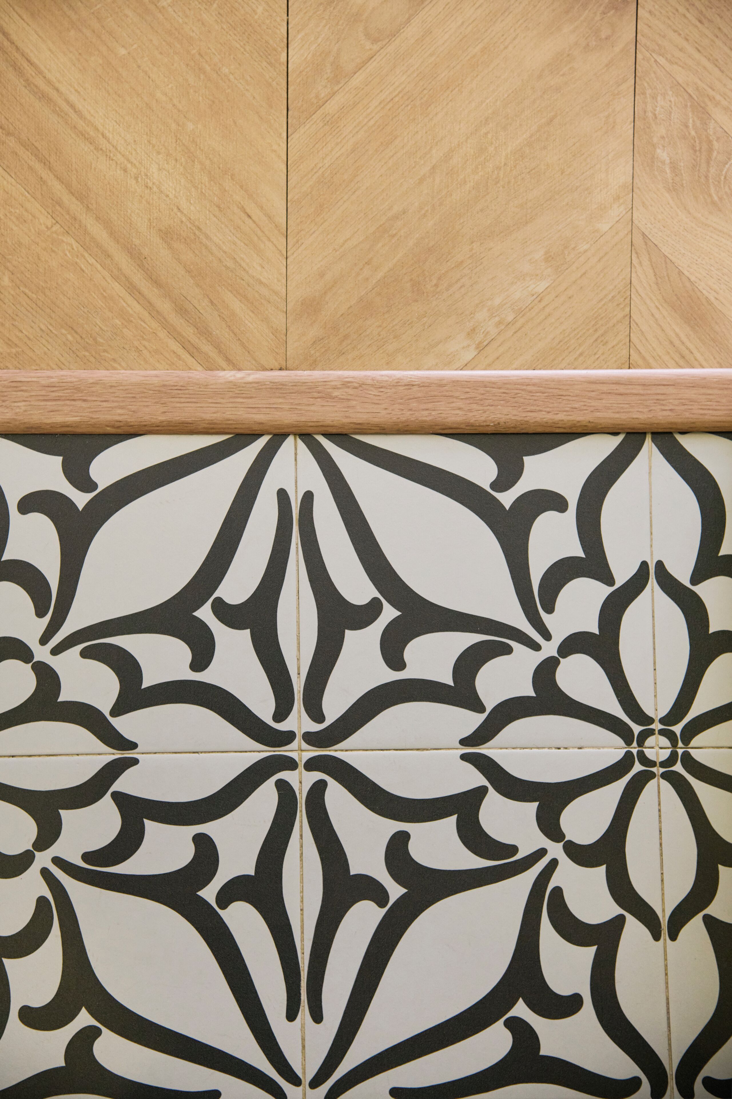 Un mur recouvert de carreaux décorés d’un motif géométrique.