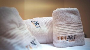 A pair of white socks with embroidered text on the side.