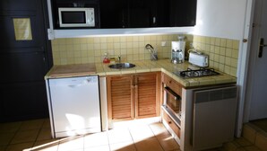 A compact kitchen with a microwave, sink, coffee maker, toaster, and a small refrigerator. - T3 exceptional sea view with large equipped terrace (Cassis)