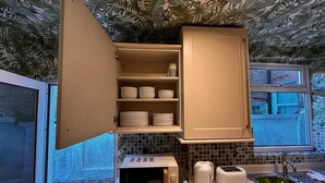 Une cuisine équipée d’un four à micro-ondes, d’un grille-pain et d’un évier.