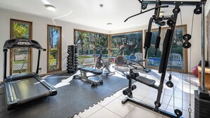 A gym with treadmills, elliptical machines, and weight equipment. - Relaxing Family Condo with Ocean View & Pools in Costa Algarrobo (El Yeco)