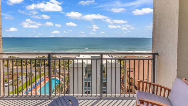 A balcony with a view of the ocean, a pool, and a building with balconies. - Ocean Forest Plaza 912 (Myrtle Beach)