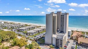 A coastal hotel with multiple high-rise buildings, a beach view, and a parking area. - Ocean Forest Plaza 912 (Myrtle Beach)
