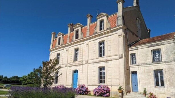 A large, historic building with a symmetrical facade, multiple windows, and a prominent entrance. - Gîte Bambou - Country charm and heated swimming pool in the heart of Charente (Chadurie)
