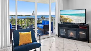 A balcony with a TV, a sofa, and a fireplace. - Destin West Bayside Sandpiper #505 (Fort Walton Beach)