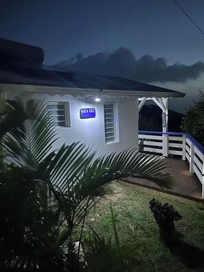 A house with a porch, a sign reading 'KAZA CÉLI', and a view of the sky. - Bungalow in the heart of nature  (Deshaies)