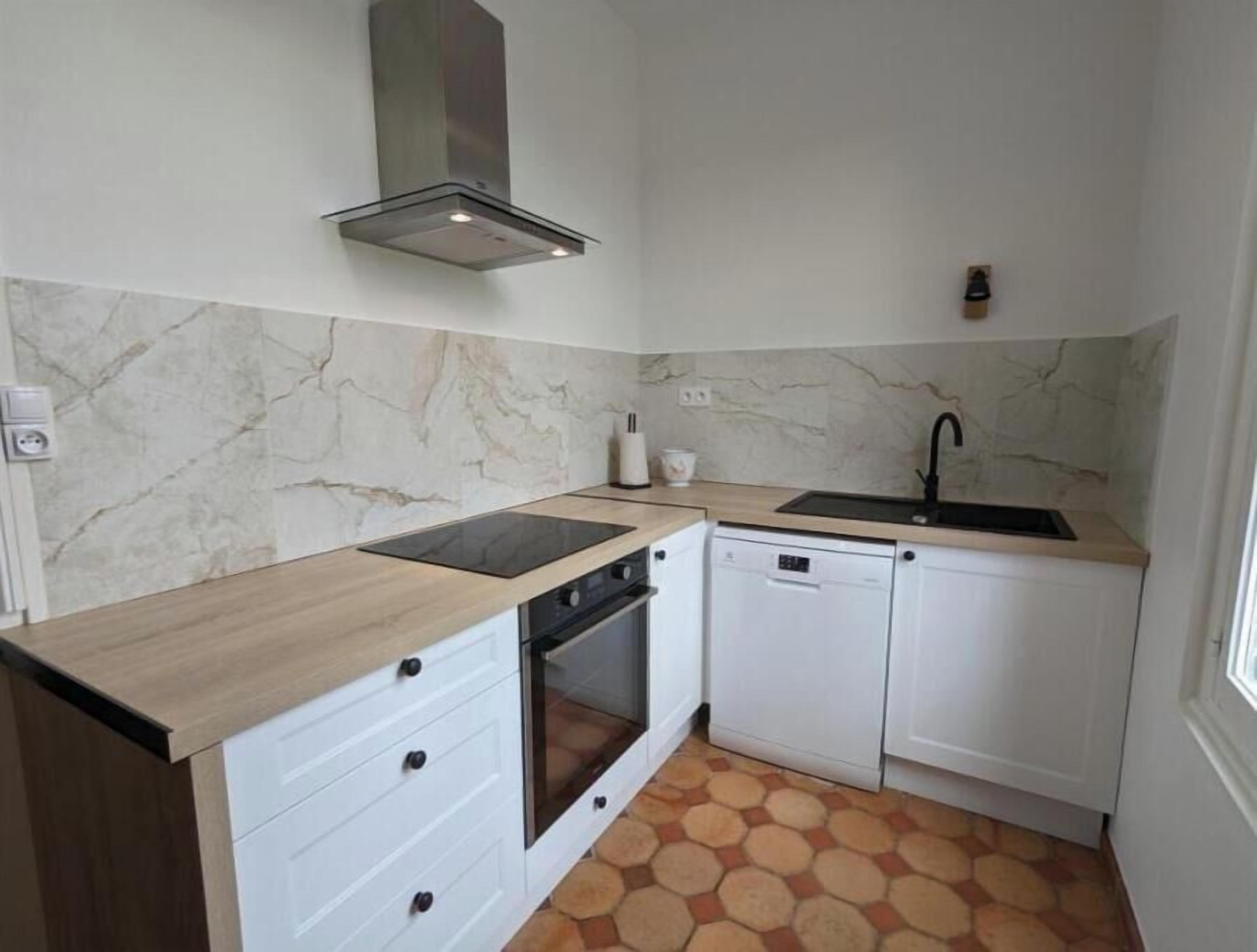 A compact kitchen with a stove, oven, dishwasher, and a sink.