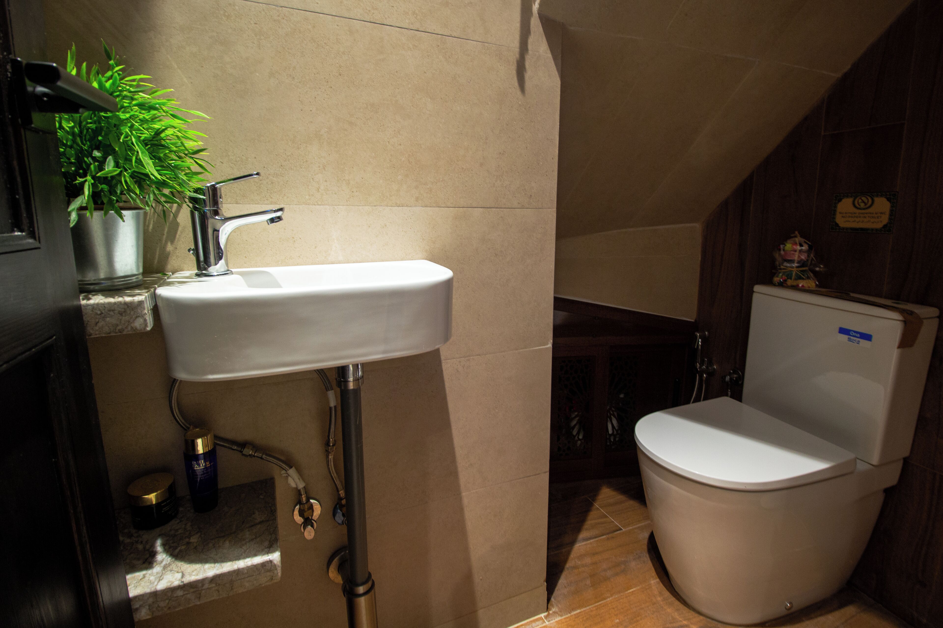 A bathroom with a white sink, a toilet, and a shower area.