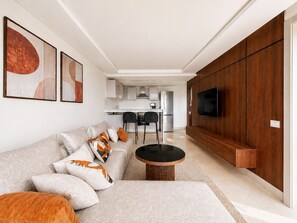 Ein modernes Wohnzimmer mit Sofa, Couchtisch und einem Kunstwerk an der Wand.