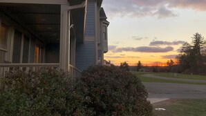 A residential building with a porch, a garage door, and a driveway. - Deep Creek 365 Water Access 5 BR 5.5 BA Indoor Pool, Hot Tub, Theater, Dogs free (Swanton)