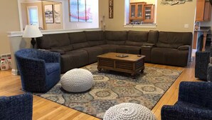 A living room with a sectional sofa, two armchairs, a coffee table, and a rug. - Deep Creek 365 Water Access 5 BR 5.5 BA Indoor Pool, Hot Tub, Theater, Dogs free (Swanton)
