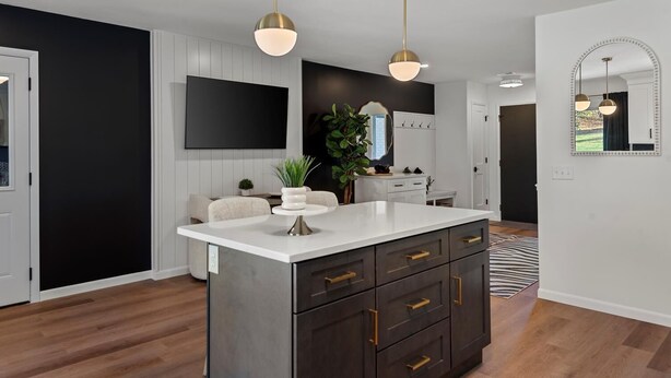 A modern kitchen with a large island, pendant lights, and a black and white color scheme. - Top-Rated Premier Modern Getaway (Petersburg)