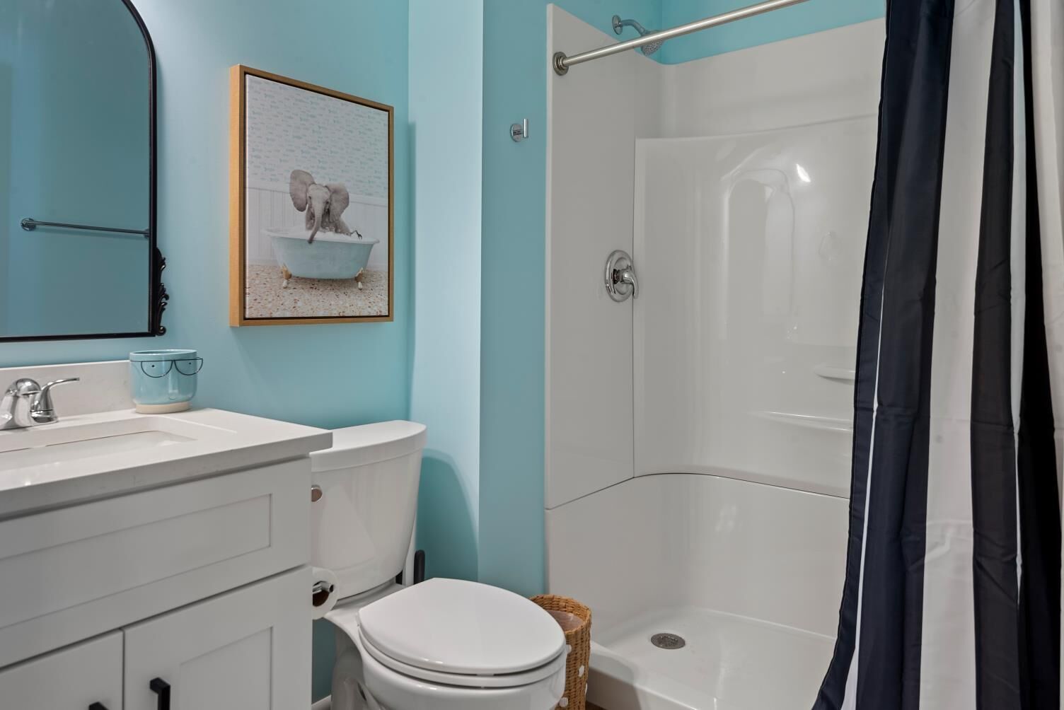 Ein Badezimmer mit Toilette, Waschbecken, Badewanne und Duschvorhang.