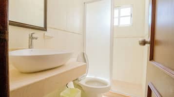 A bathroom with a sink, toilet, and shower.