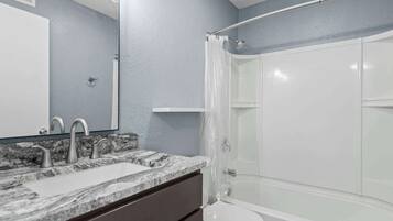 Shower, hair dryer, towels, shampoo